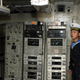 A North Korean navy soldier stands guard at a communication room in the United States' navy spy ship USS Pueblo on a river in Pyongyang May 3, 2004. The spy ship was seized by the North Korean navy with 83 crew in 1968. The 82 survivors were freed after nearly a year of tense negotiations. About 300 South Korean workers completed on Monday a four-day trip to Pyongyang for an inter-Korean May Day celebration.
